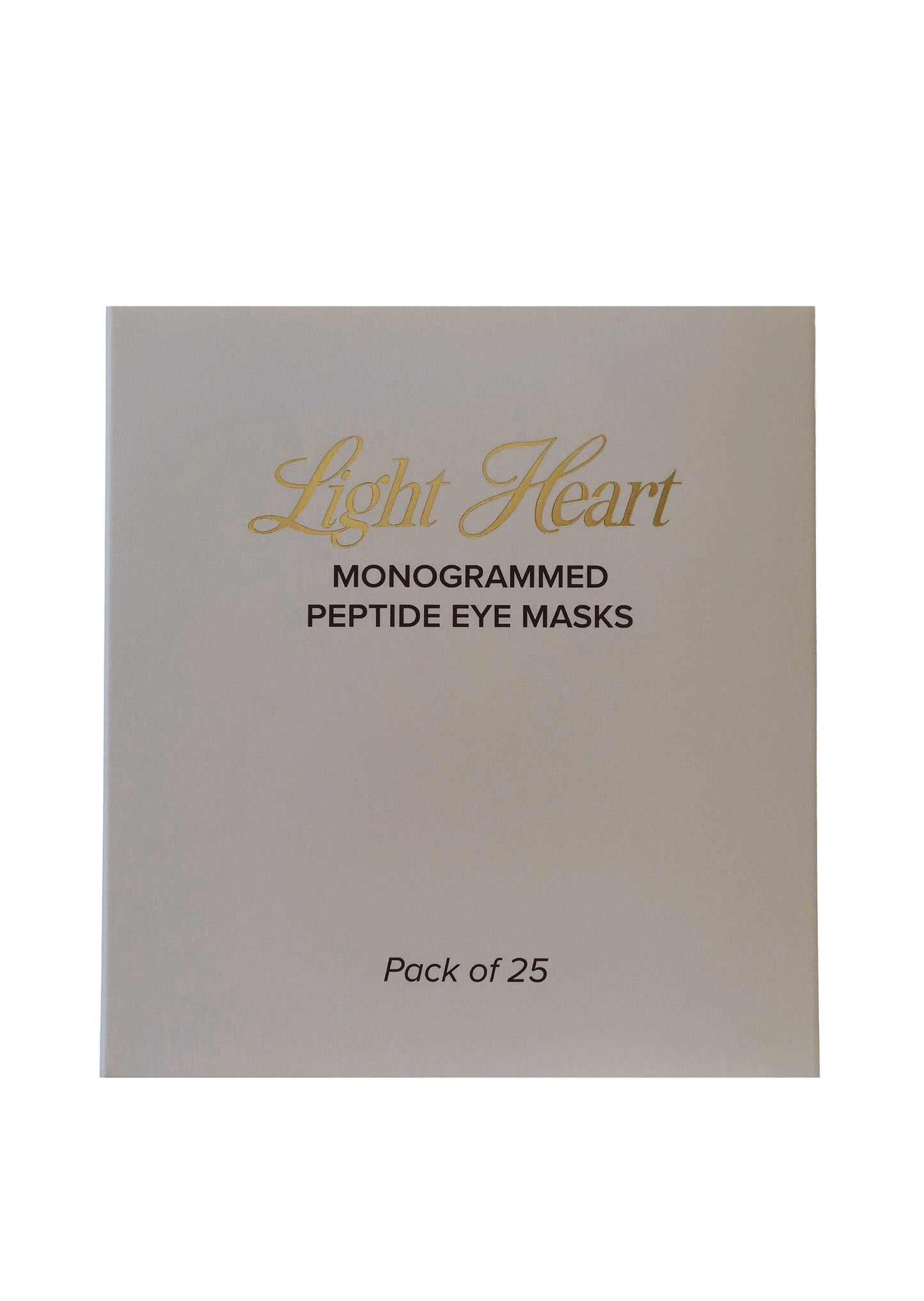 Pack of 25 monogrammed peptide eye masks by Light Heart on a beige background